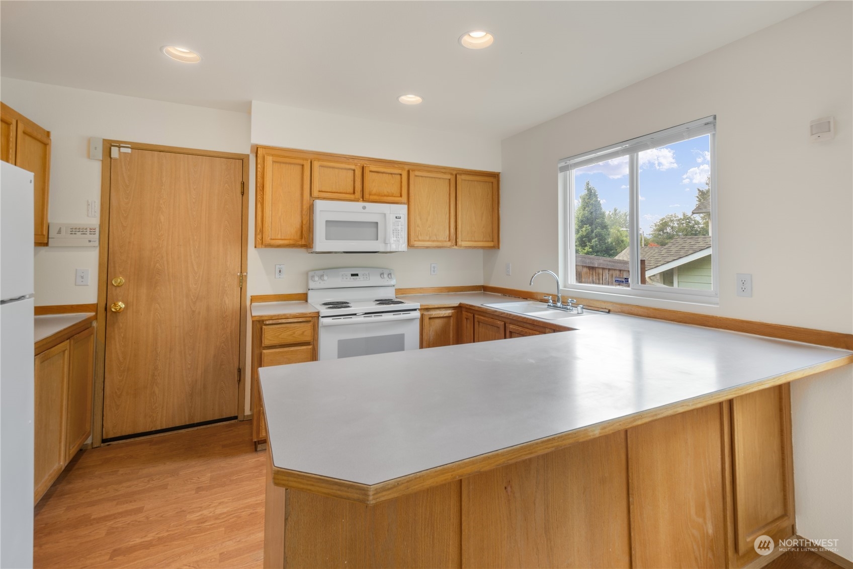 2313 211th Street Southeast Bothell, WA 98021 - Photo 6 of 25 a kitchen that has a sink a stove and a refrigerator