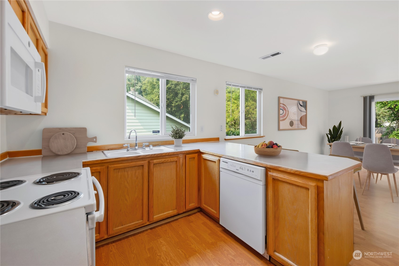 2313 211th Street Southeast Bothell, WA 98021 - Photo 7 of 25 a kitchen with stainless steel appliances granite countertop a sink stove and refrigerator