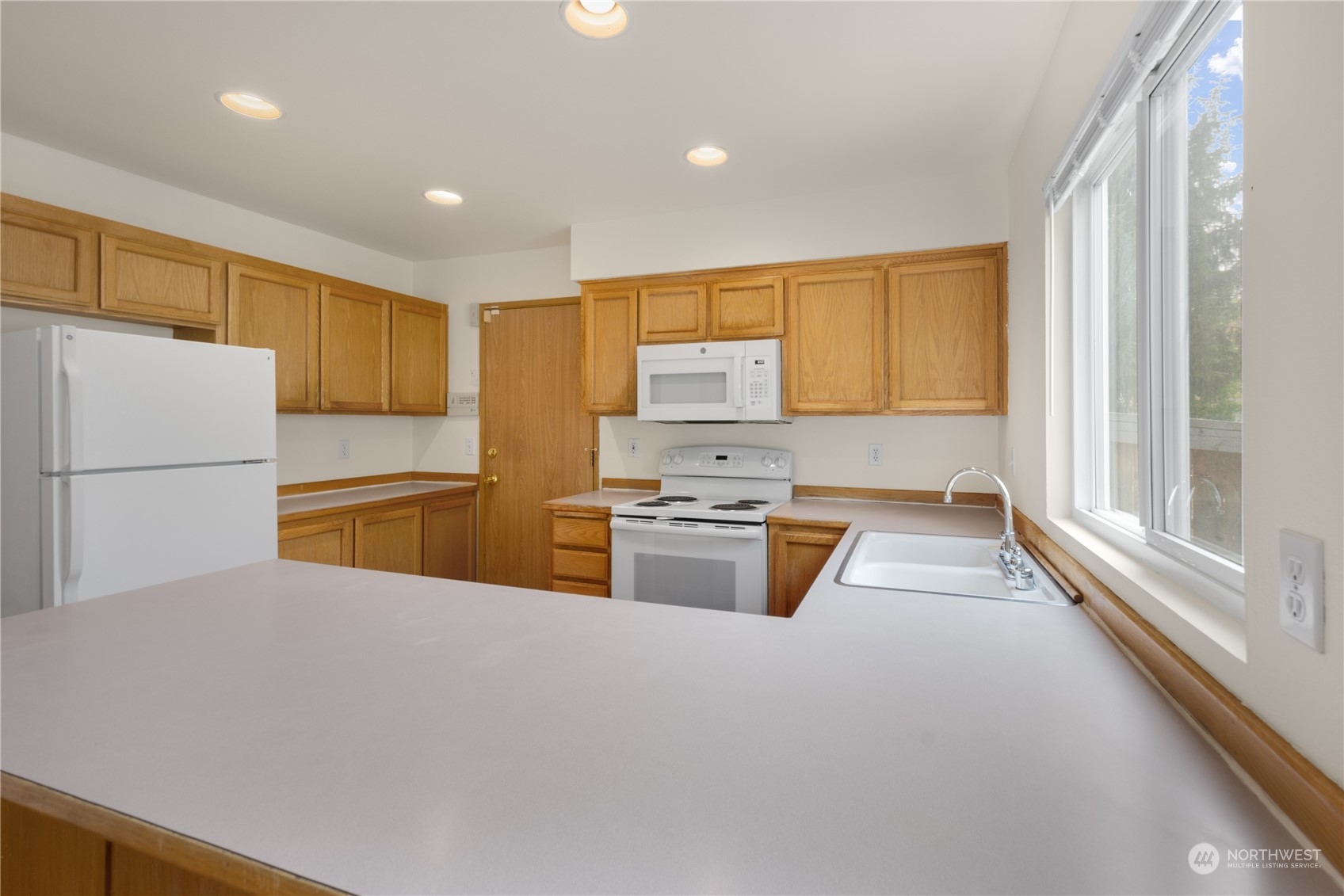 2313 211th Street Southeast Bothell, WA 98021 - Photo 8 of 25 a kitchen with stainless steel appliances granite countertop a refrigerator sink and stove