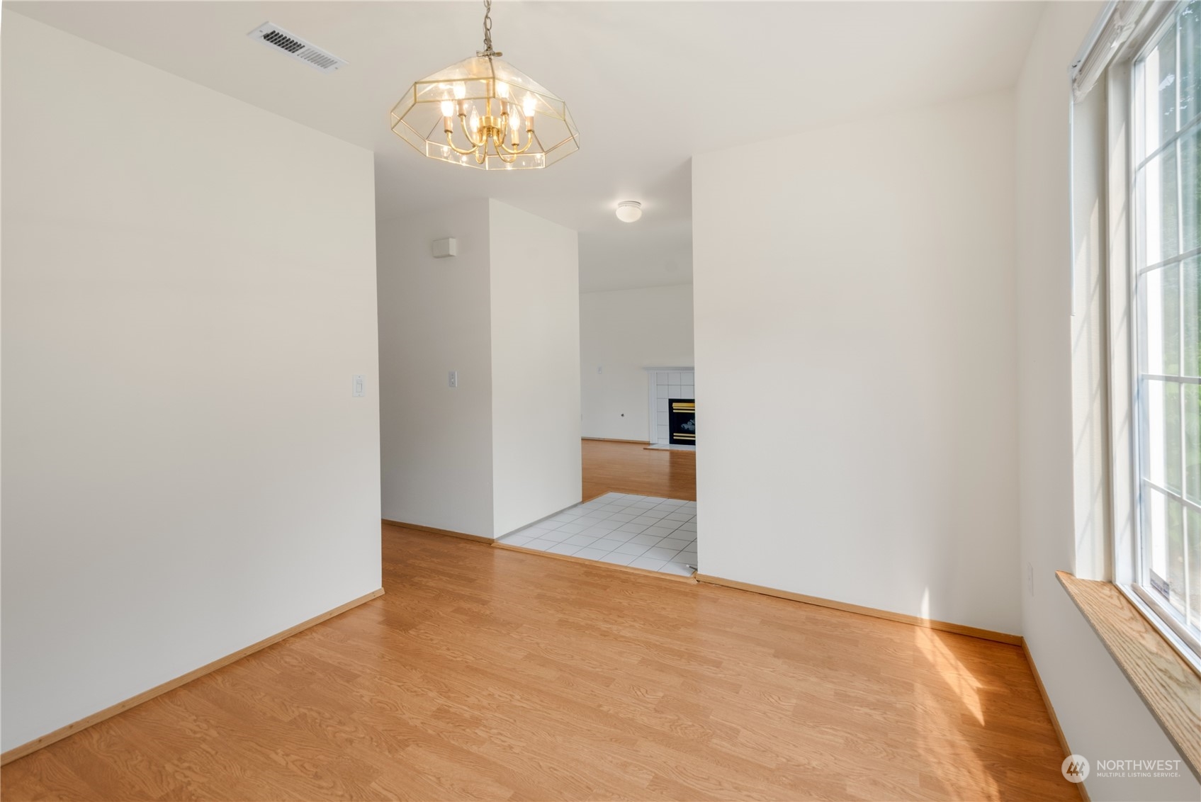 2313 211th Street Southeast Bothell, WA 98021 - Photo 10 of 25 wooden floor in an empty room with a window