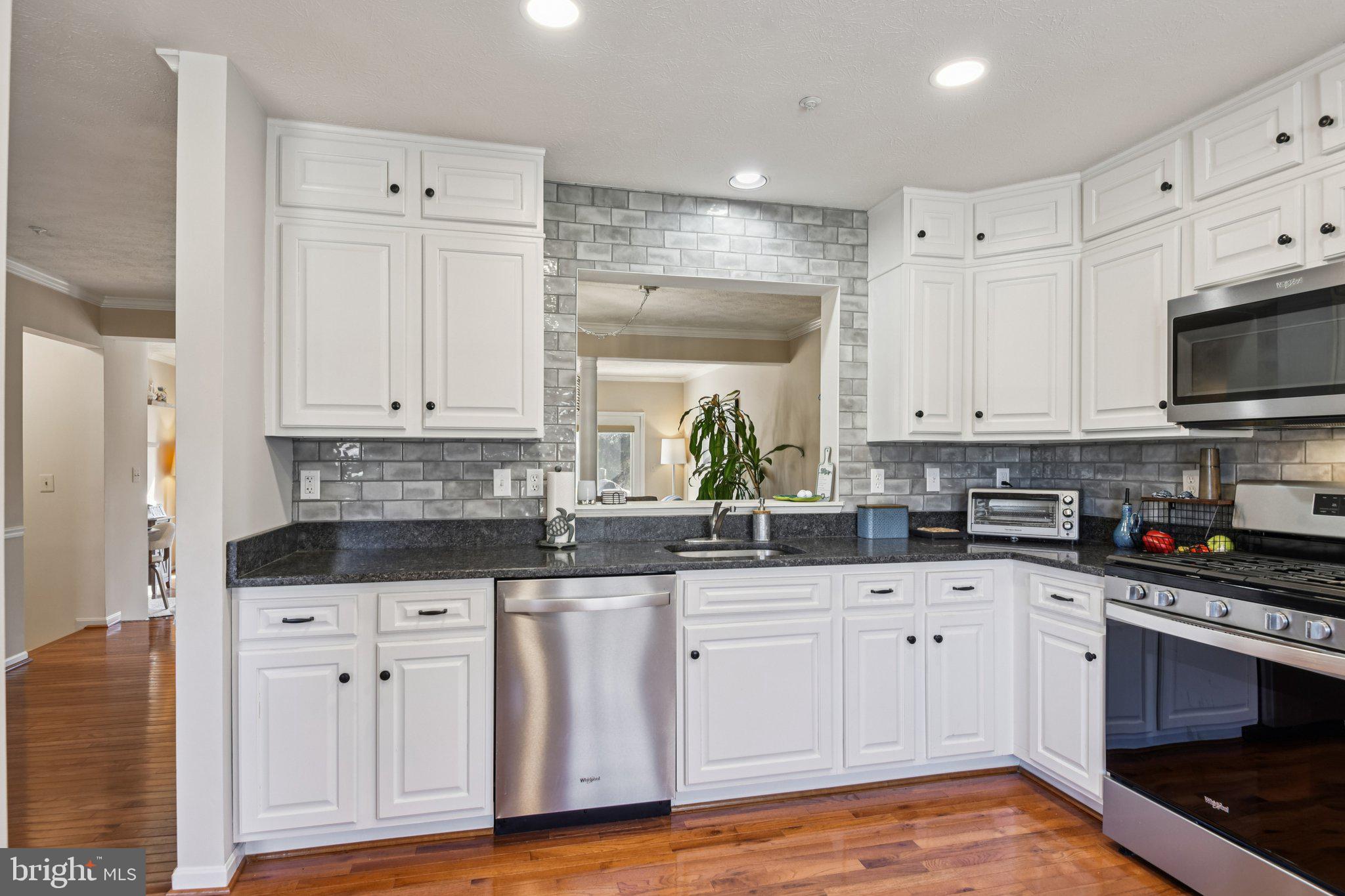 2612 Tallwind Court Crofton, MD 21054 - Photo 13 of 38 a kitchen with granite countertop white cabinets and stainless steel appliances