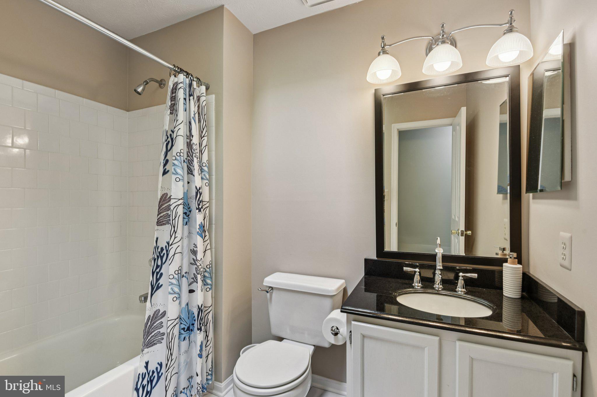2612 Tallwind Court Crofton, MD 21054 - Photo 21 of 38 a bathroom with a granite countertop sink toilet and shower