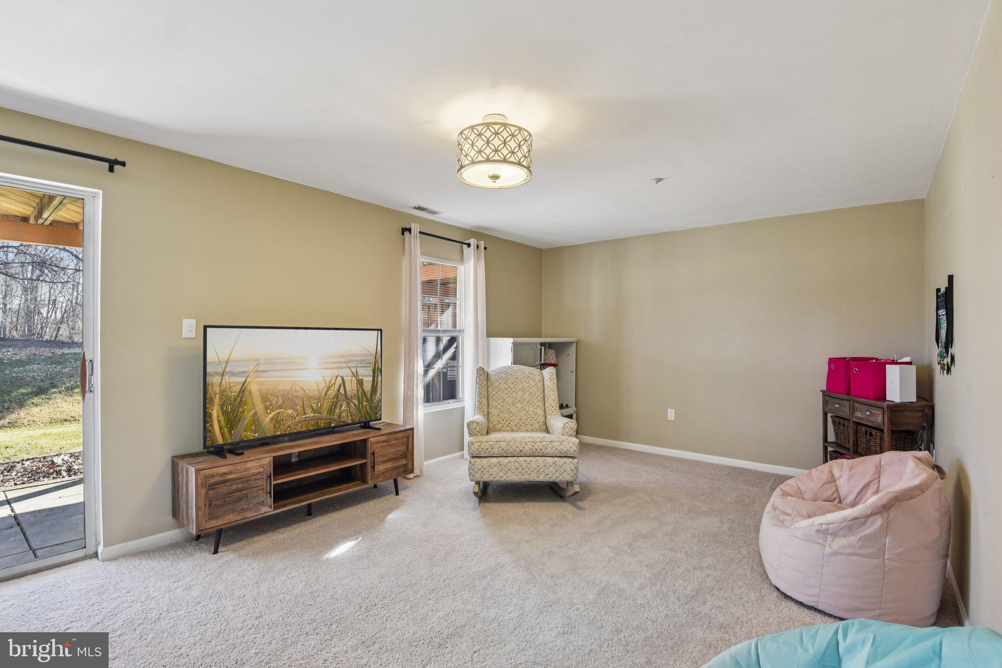 2612 Tallwind Court Crofton, MD 21054 - Photo 29 of 38 a bedroom with furniture and a flat screen tv