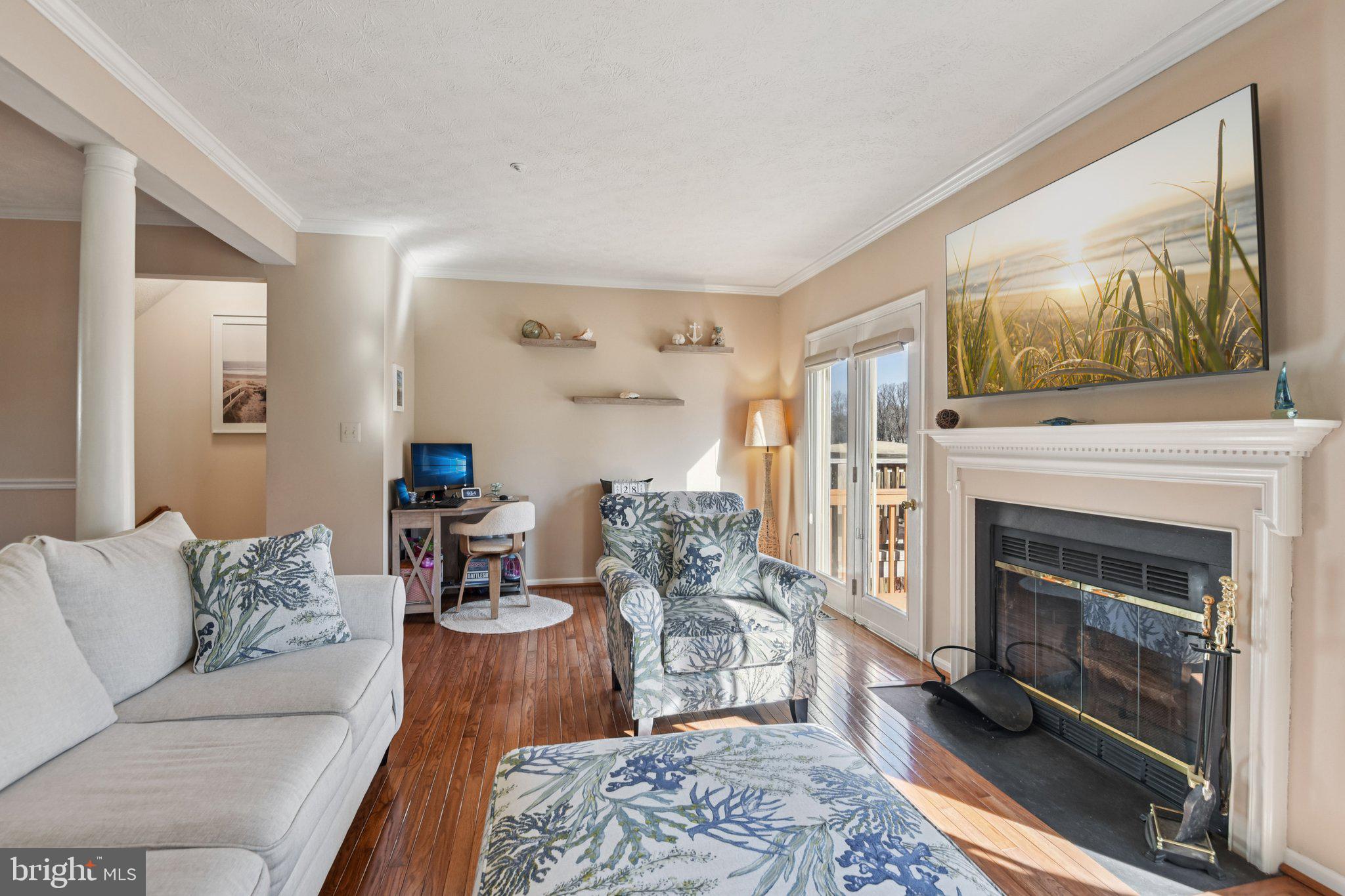 2612 Tallwind Court Crofton, MD 21054 - Photo 6 of 38 a living room with furniture a flat screen tv and a fireplace