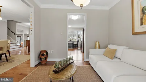 a kitchen with stainless steel appliances granite countertop a refrigerator a stove and a dining table with wooden floor