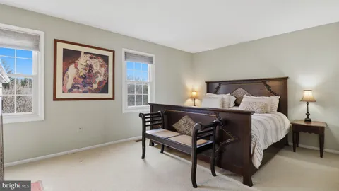 a bedroom with a bed and a lamp