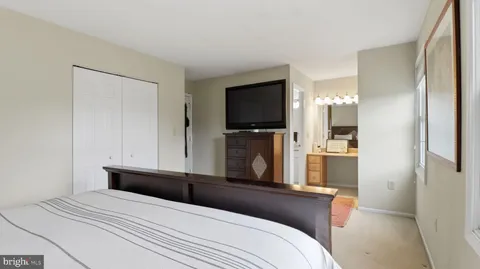 a view of a bedroom with a window and furniture
