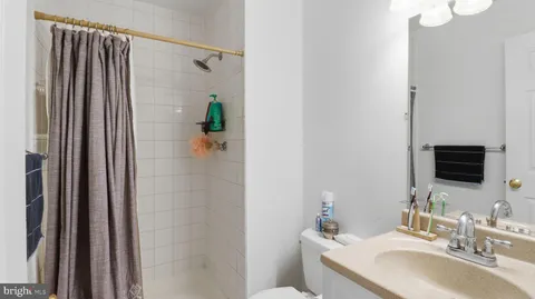 a bathroom with a sink toilet and mirror