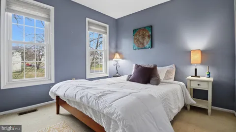 a living room with furniture a rug and a flat screen tv