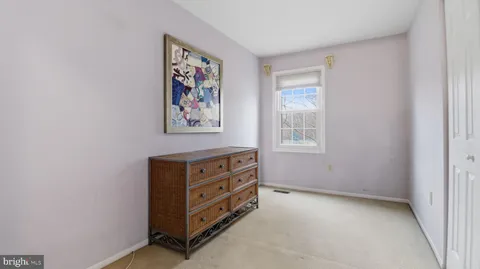 a living room with furniture a flat screen tv and a dresser
