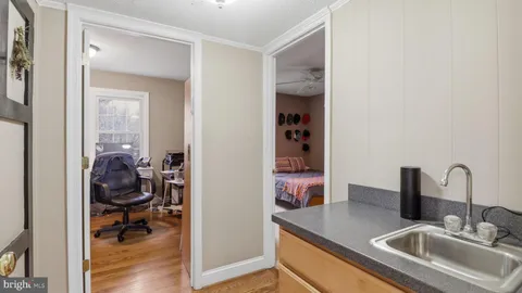 a blue couch sitting next to a window