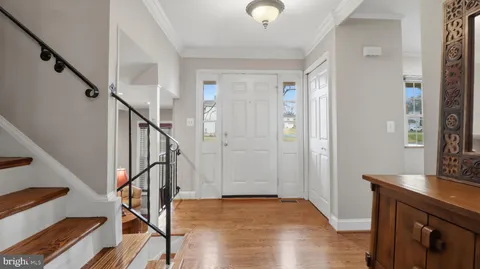 a view of a dining room with furniture a chandelier and wooden floor