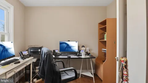 a view of a hallway with furniture and windows