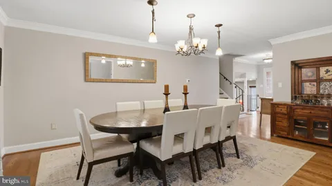 a view of a dining room with furniture and chandelier