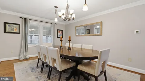 a view of a dining room with furniture and chandelier