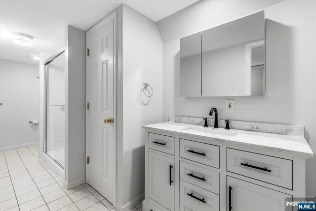 a view of cabinets a sink wooden floor and a window in a room