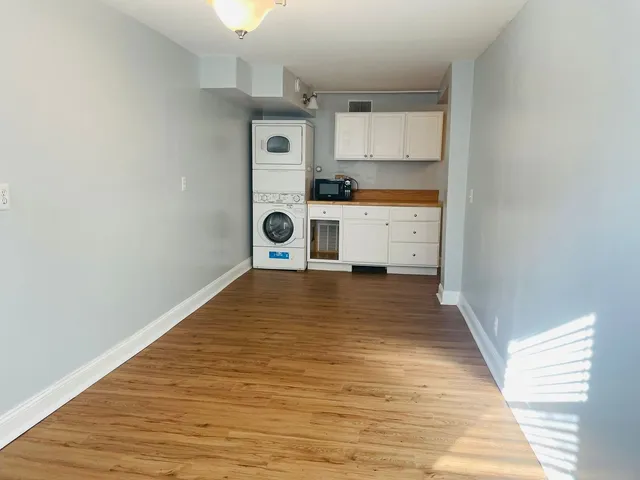 a kitchen with wooden floors and white appliances