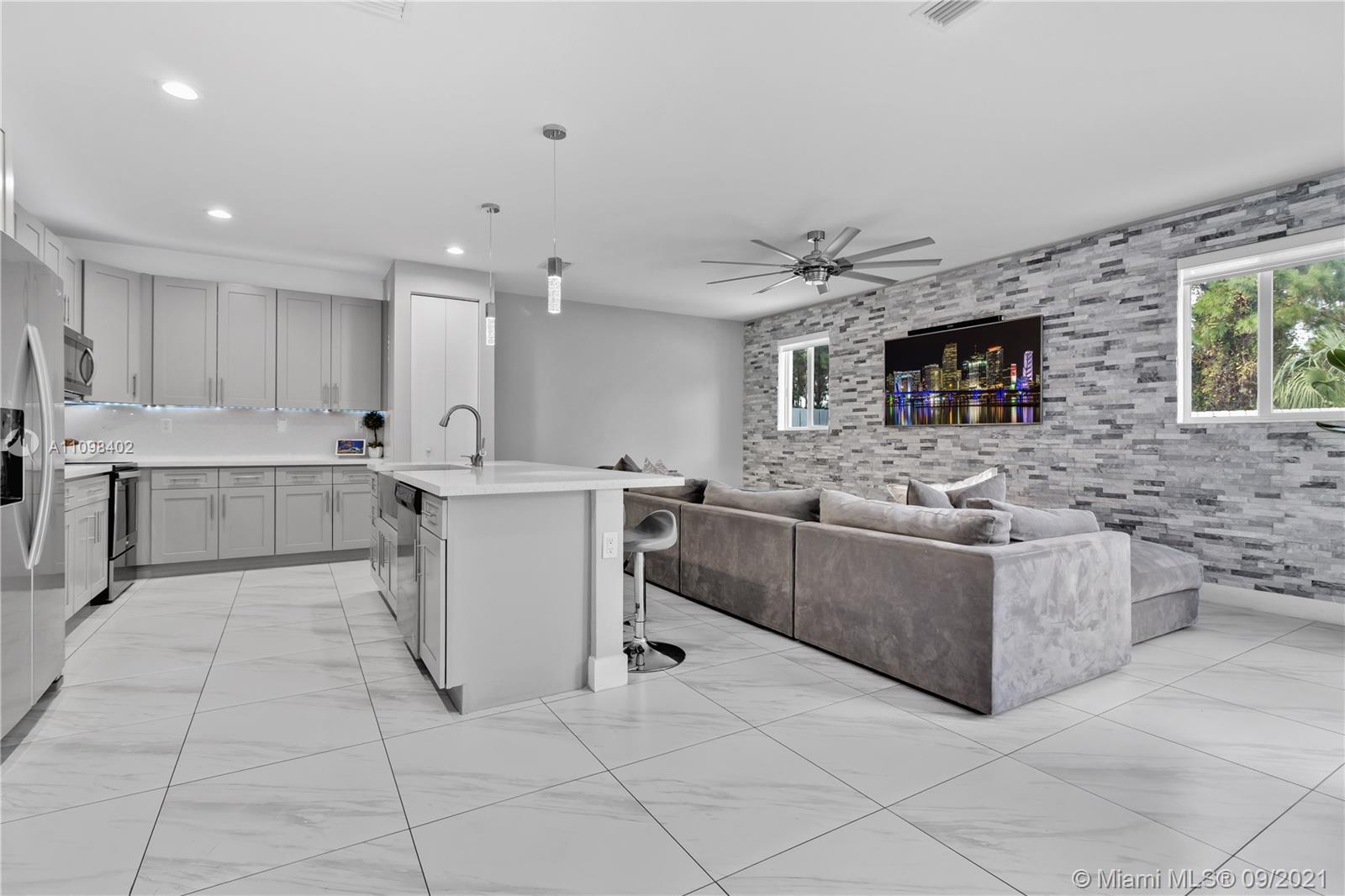 18334 Southwest 139th Path Miami, FL 33177 - Photo 2 of 62 a large white kitchen with stainless steel appliances granite countertop a stove and a sink