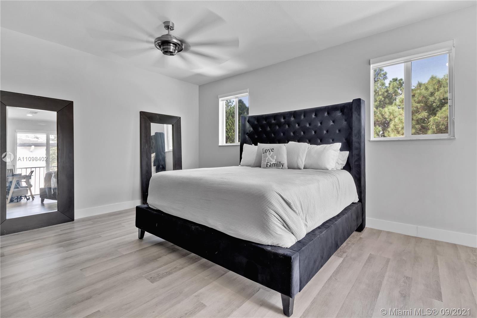 18334 Southwest 139th Path Miami, FL 33177 - Photo 13 of 62 a bedroom with a large bed and a chandelier