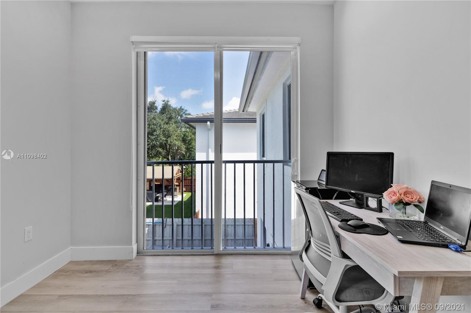 18334 Southwest 139th Path Miami, FL 33177 - Photo 16 of 62 a view of a workspace with furniture and a window