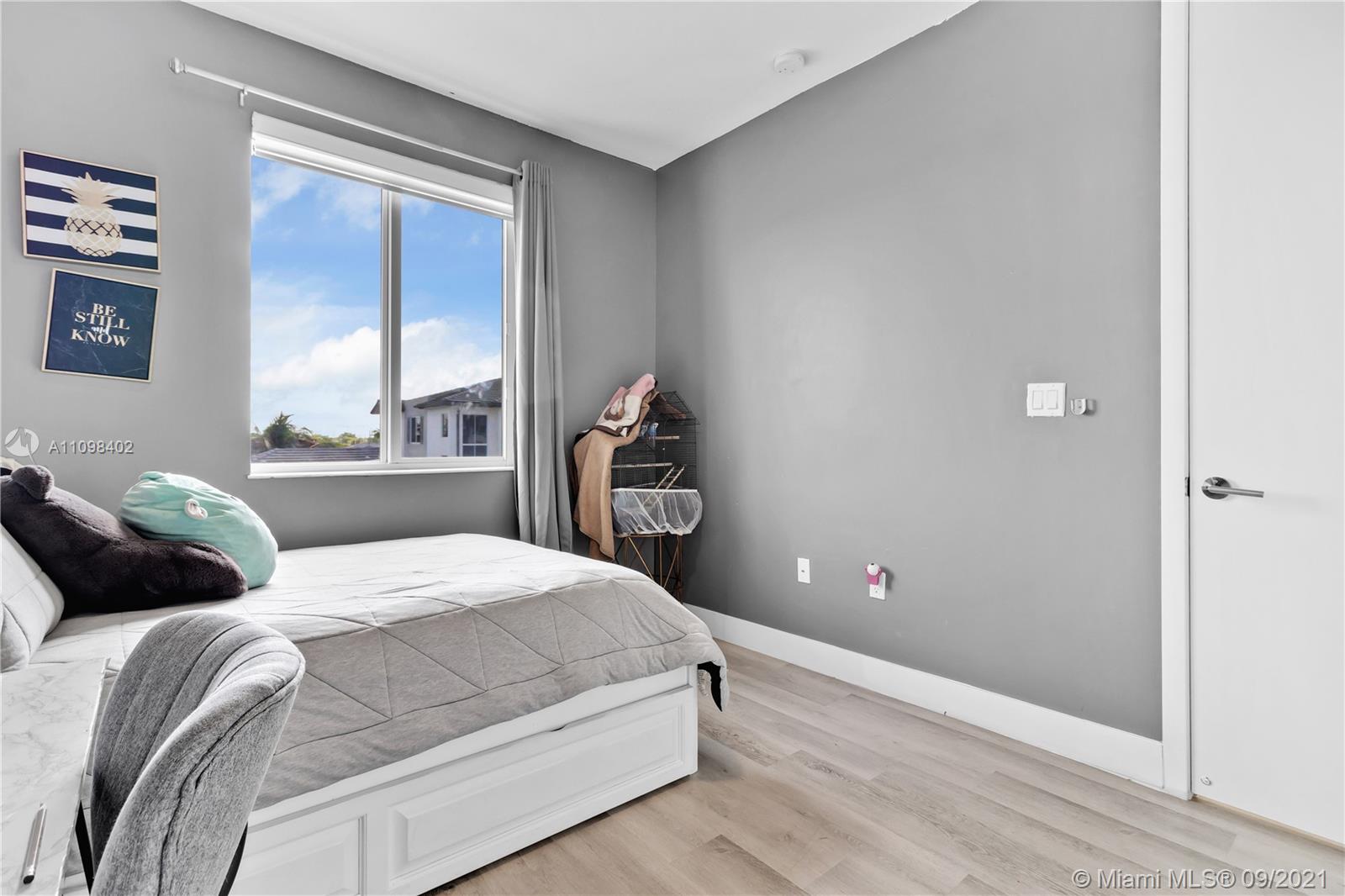 18334 Southwest 139th Path Miami, FL 33177 - Photo 18 of 62 a bedroom with a bed and painting on the wall