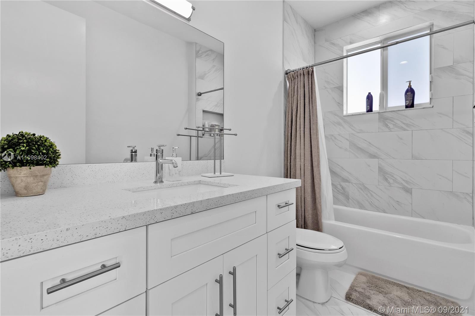 18334 Southwest 139th Path Miami, FL 33177 - Photo 19 of 62 a bathroom with a granite countertop sink toilet and shower