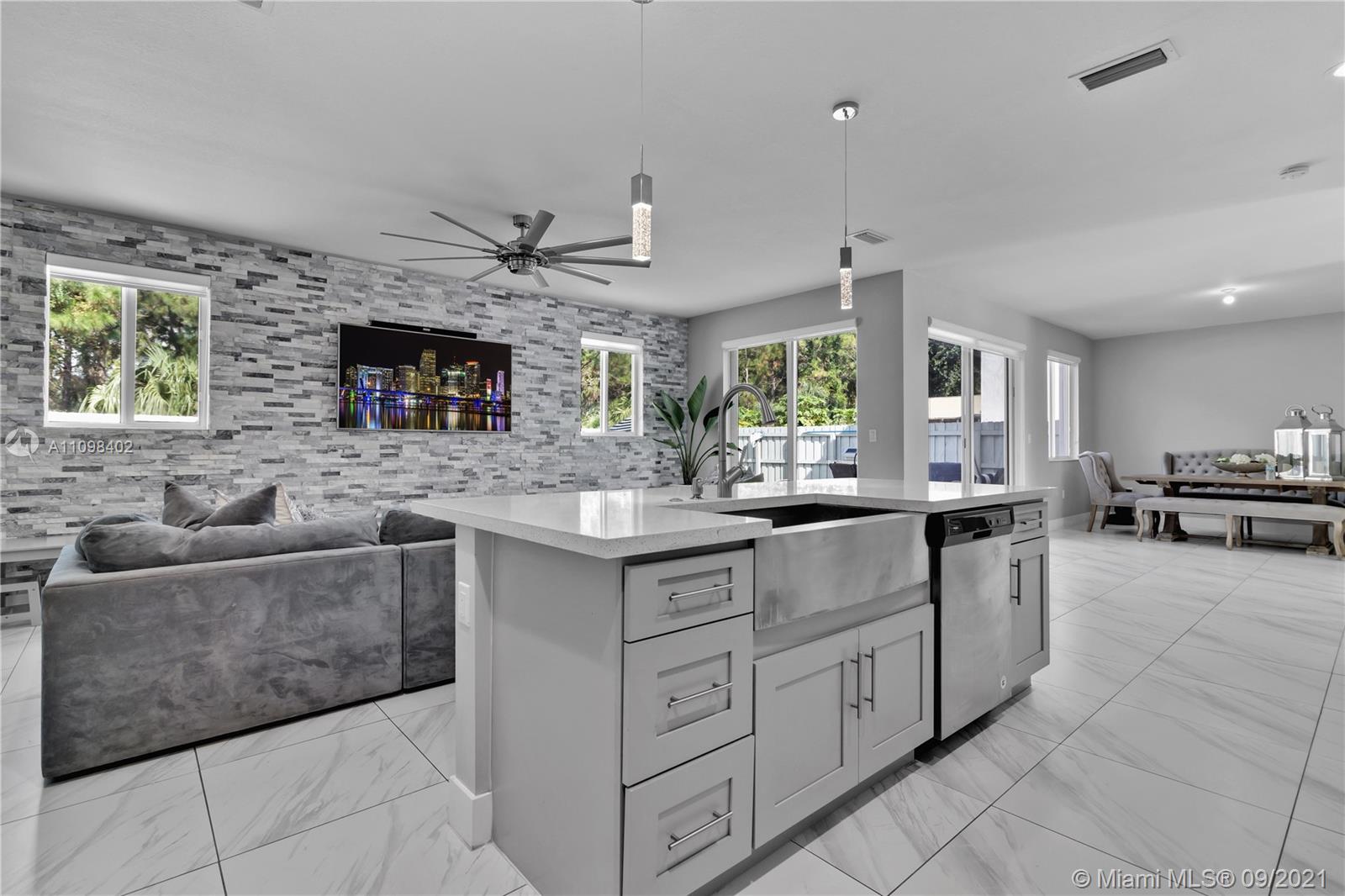 18334 Southwest 139th Path Miami, FL 33177 - Photo 3 of 62 a kitchen with stainless steel appliances granite countertop a sink and cabinets