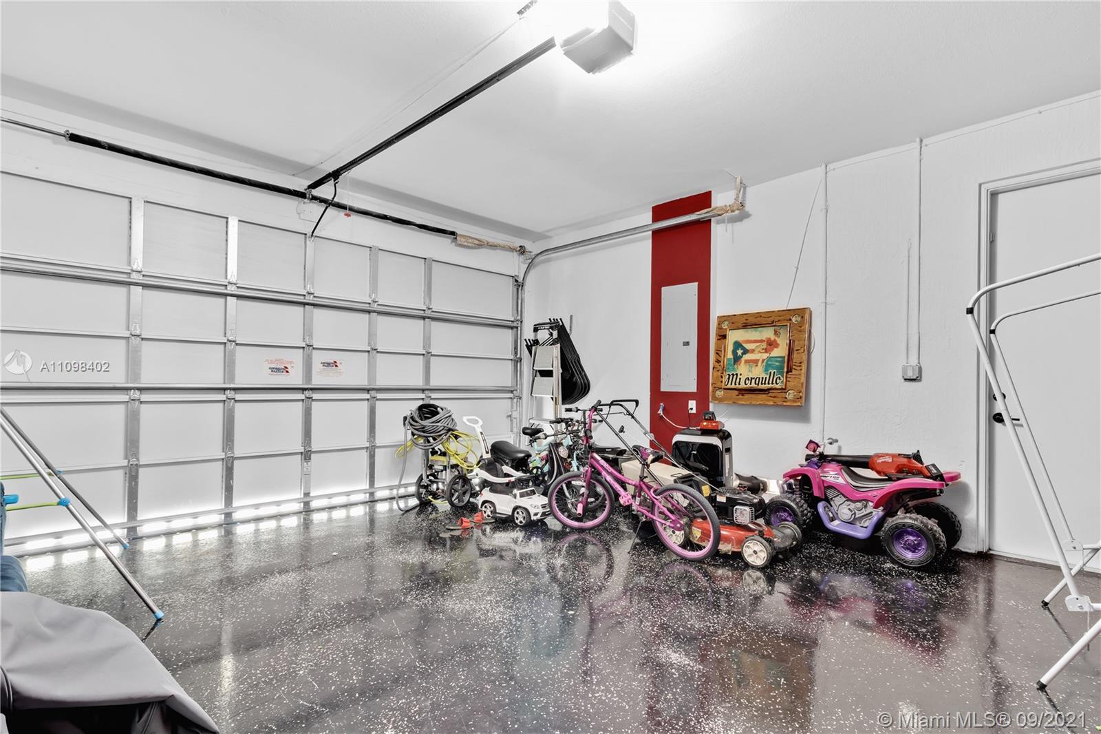 18334 Southwest 139th Path Miami, FL 33177 - Photo 25 of 62 a view of a garage with rack and bicycle