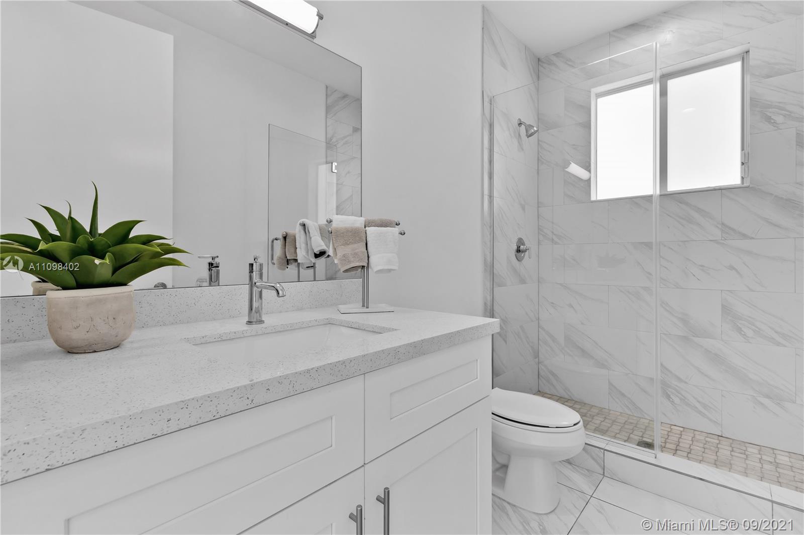 18334 Southwest 139th Path Miami, FL 33177 - Photo 26 of 62 a bathroom with a granite countertop sink a toilet and a mirror