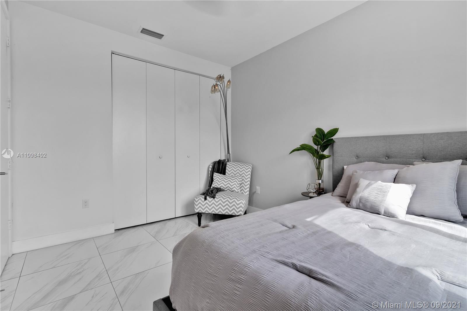 18334 Southwest 139th Path Miami, FL 33177 - Photo 28 of 62 a bedroom with a bed and a potted plant on the dresser