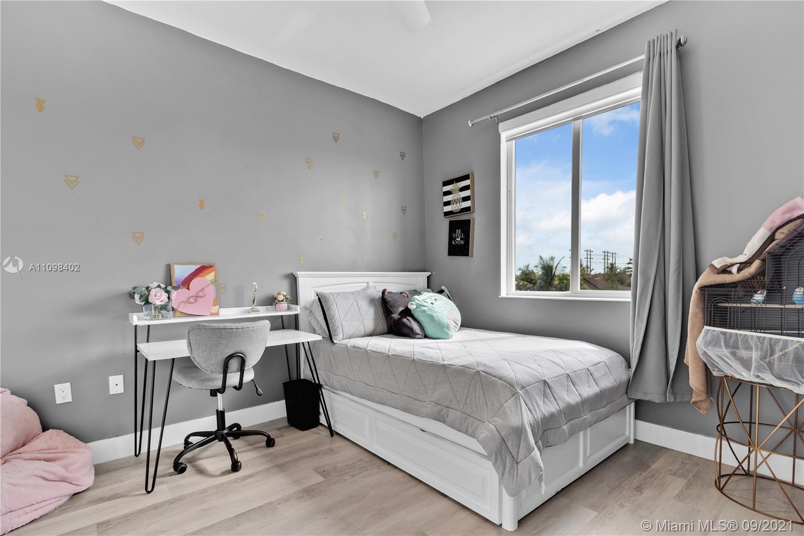 18334 Southwest 139th Path Miami, FL 33177 - Photo 29 of 62 a bedroom with a bed and a book shelf