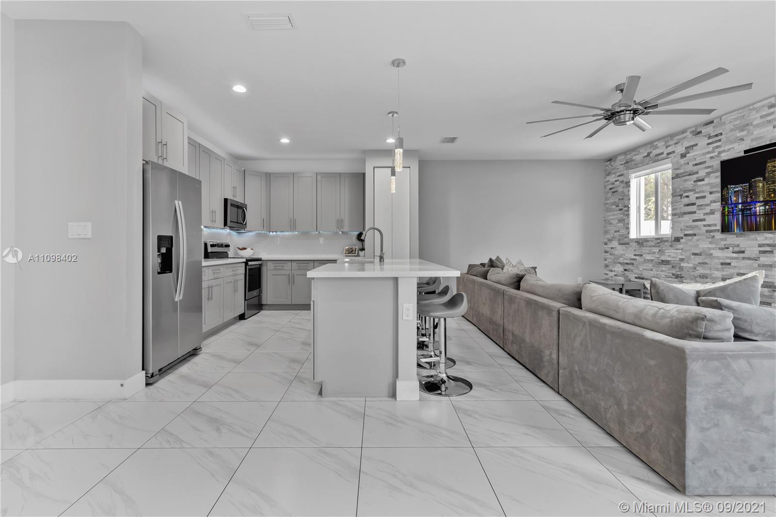 18334 Southwest 139th Path Miami, FL 33177 - Photo 30 of 62 a living room with furniture and a fireplace