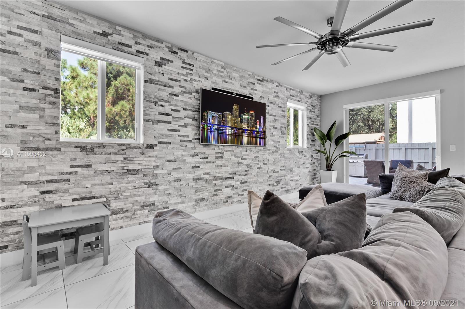 18334 Southwest 139th Path Miami, FL 33177 - Photo 33 of 62 a living room with furniture and a flat screen tv