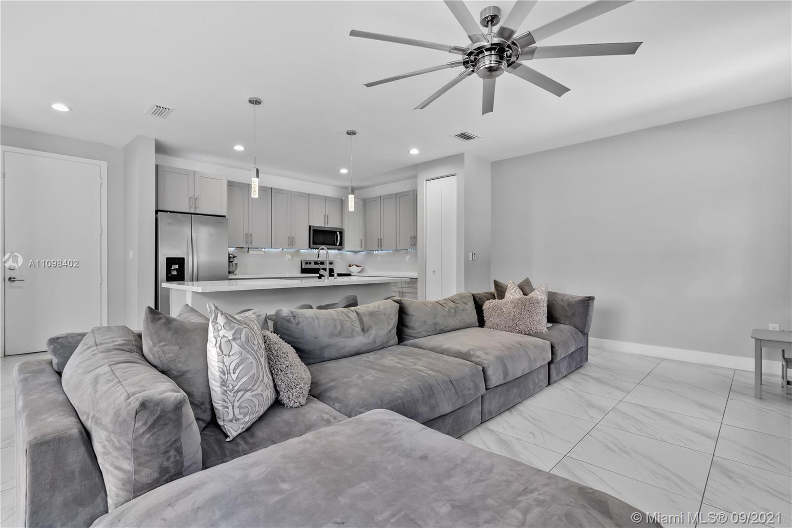 18334 Southwest 139th Path Miami, FL 33177 - Photo 34 of 62 a living room with furniture and kitchen view