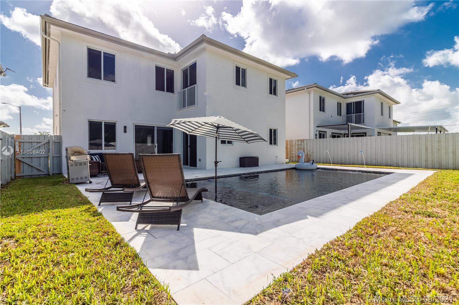 18334 Southwest 139th Path Miami, FL 33177 - Photo 36 of 62 a view of a house with swimming pool and sitting area