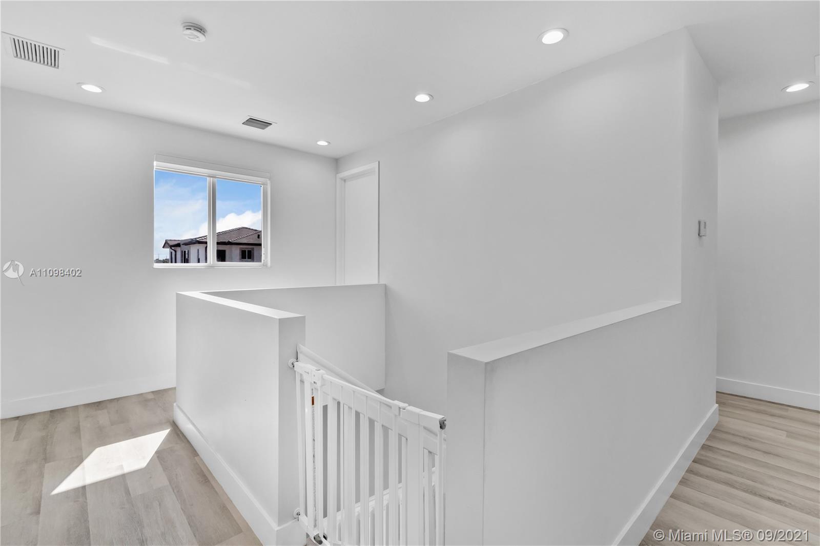 18334 Southwest 139th Path Miami, FL 33177 - Photo 41 of 62 a view of an empty room with wooden floor