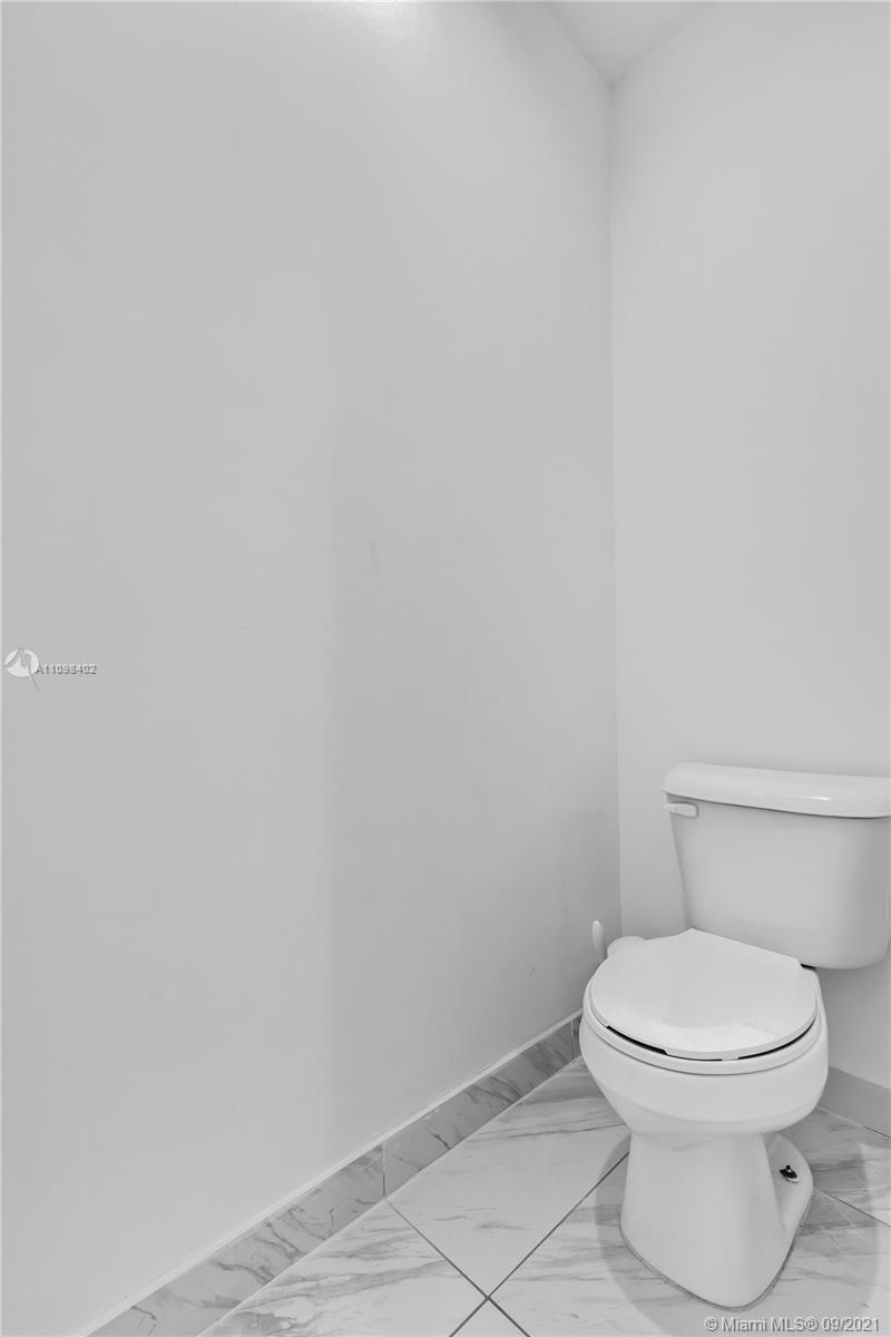 18334 Southwest 139th Path Miami, FL 33177 - Photo 48 of 62 a white toilet sitting next to a white wall