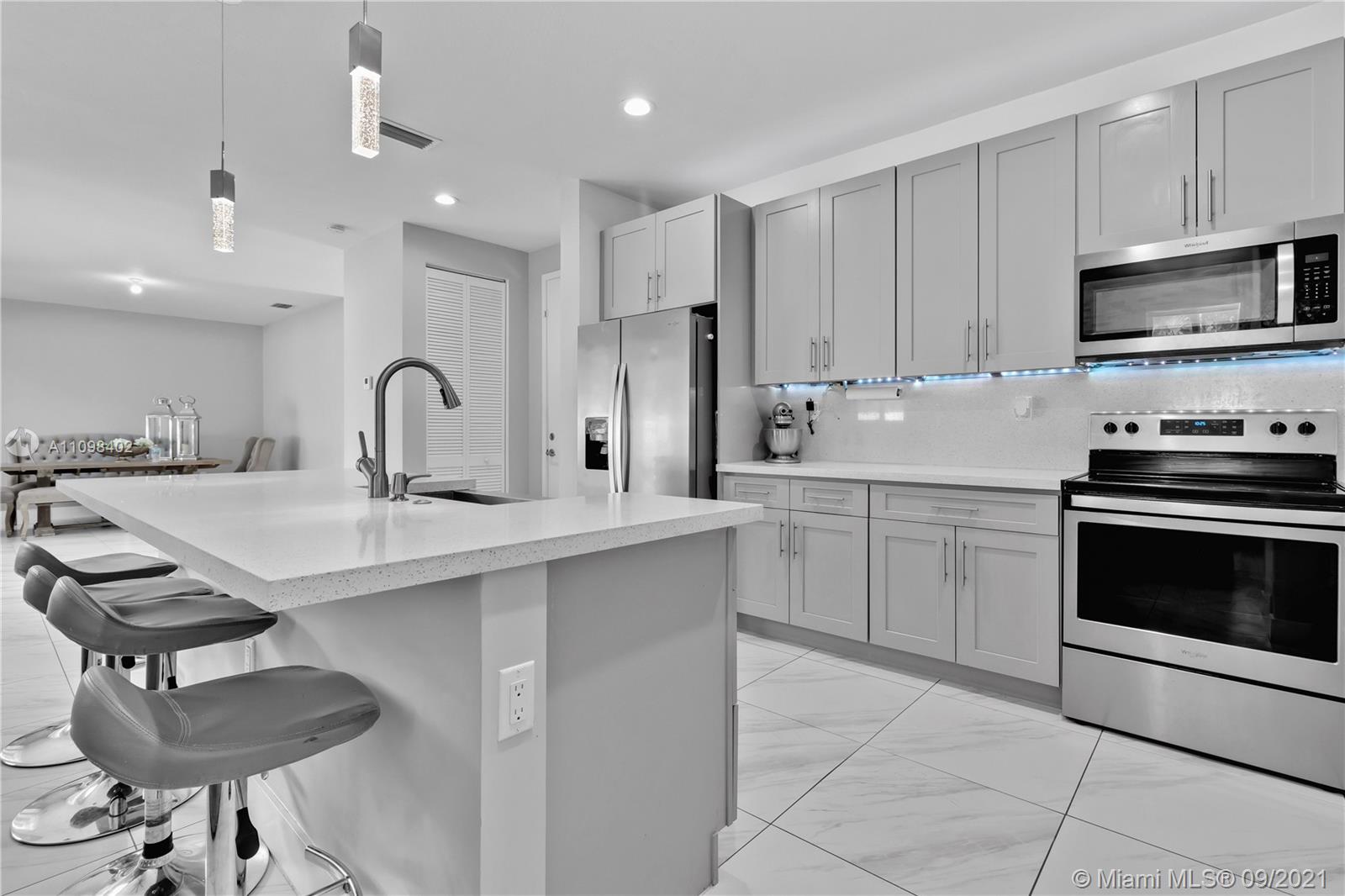 18334 Southwest 139th Path Miami, FL 33177 - Photo 7 of 62 a kitchen with a sink stainless steel appliances and cabinets