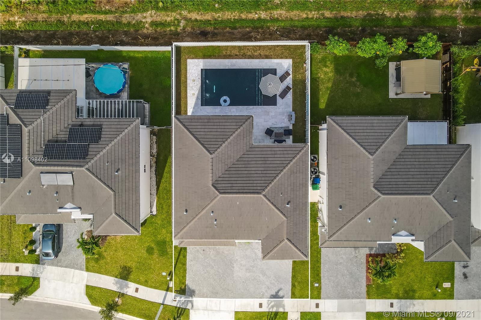 18334 Southwest 139th Path Miami, FL 33177 - Photo 61 of 62 an aerial view of a house with swimming pool and ocean view