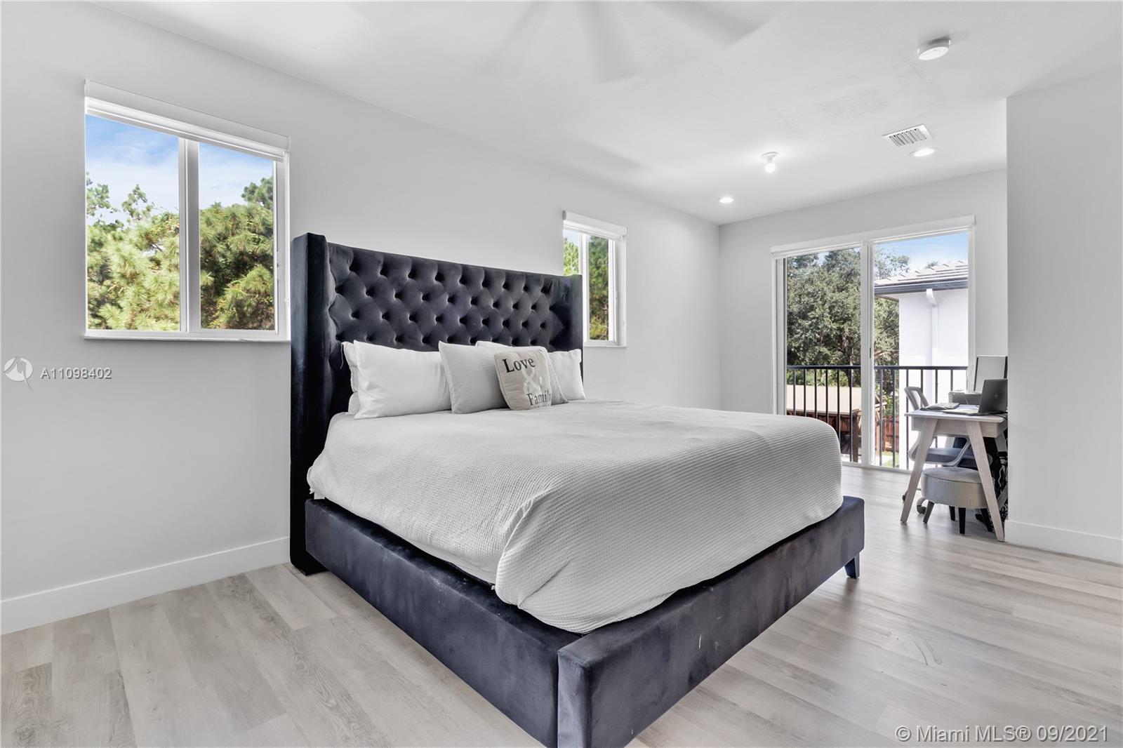 18334 Southwest 139th Path Miami, FL 33177 - Photo 8 of 62 a large bed sitting in a bedroom next to a window