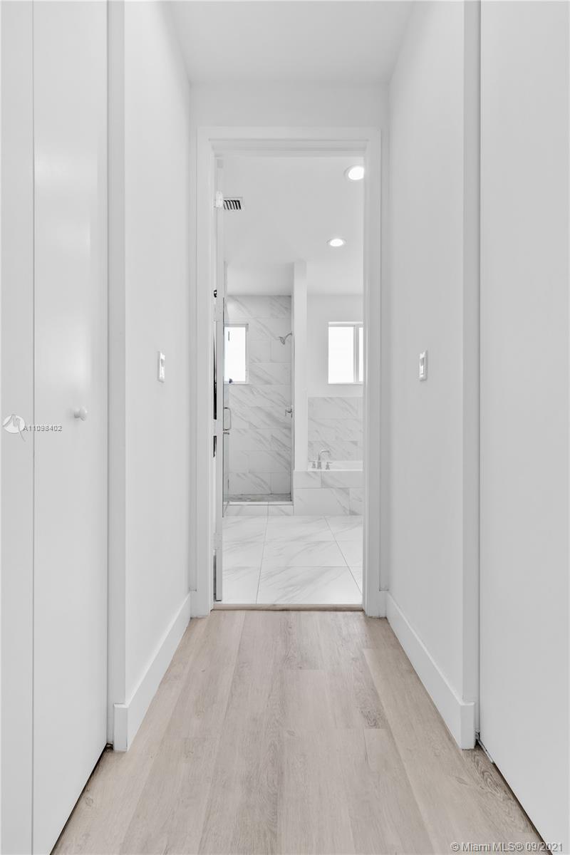 18334 Southwest 139th Path Miami, FL 33177 - Photo 10 of 62 a view of a hallway with wooden floor and a bathroom