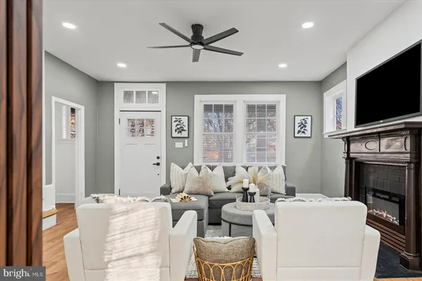 a living room with furniture a flat screen tv and a fireplace
