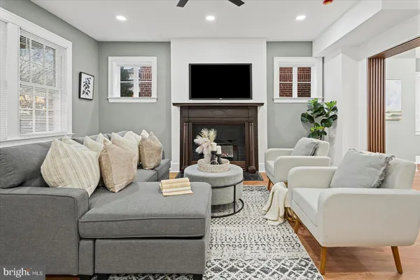 a living room with furniture a fireplace and a flat screen tv