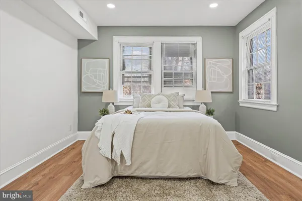 a bed sitting in a bedroom next to a window