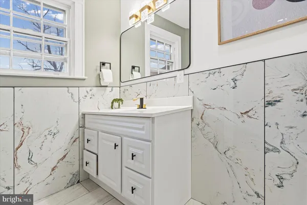 a bathroom with a sink and a mirror door