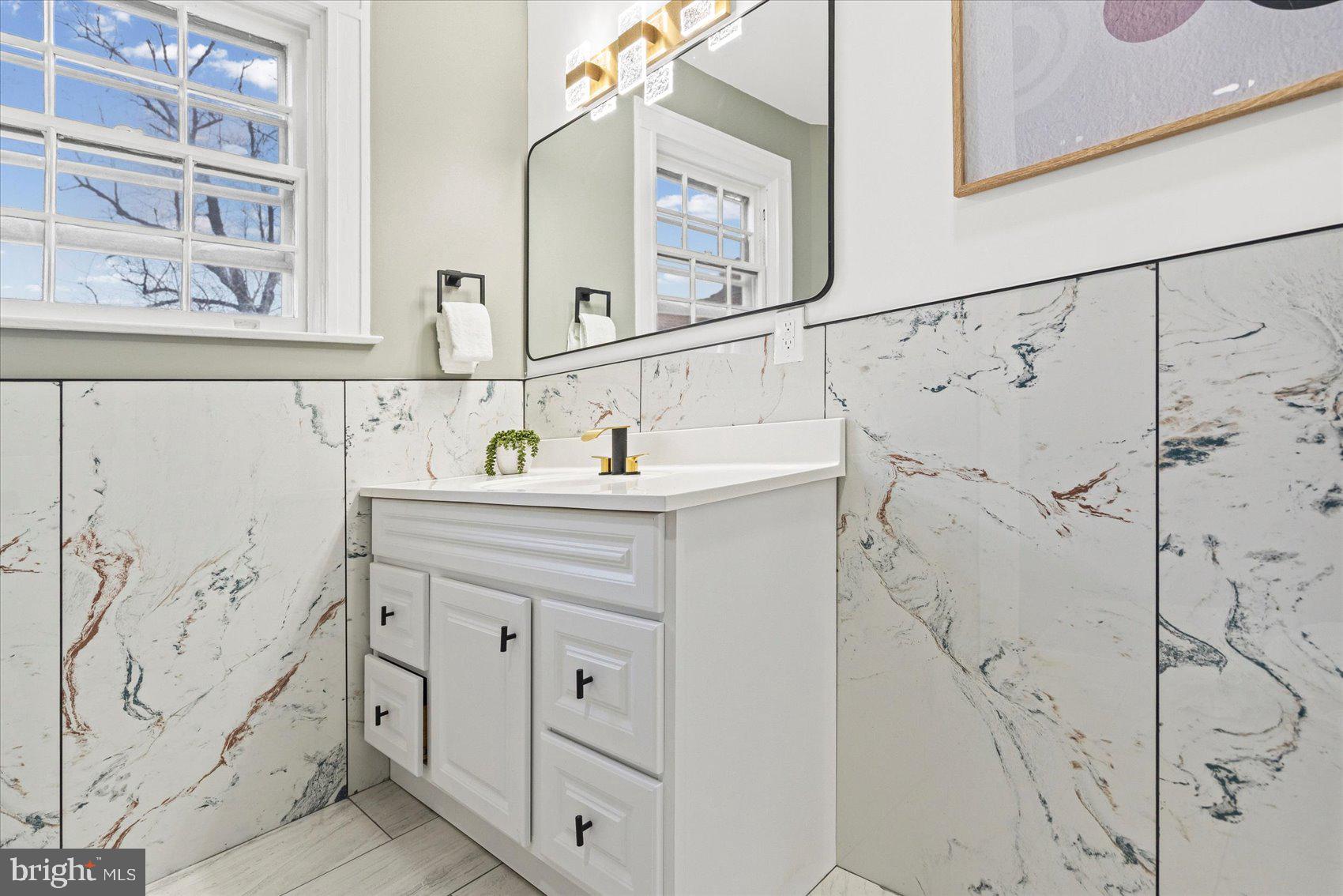 7 York Court Baltimore, MD 21218 - Photo 18 of 42 a bathroom with a sink and a mirror door