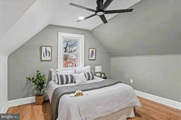 a bedroom with a large bed and a potted plant