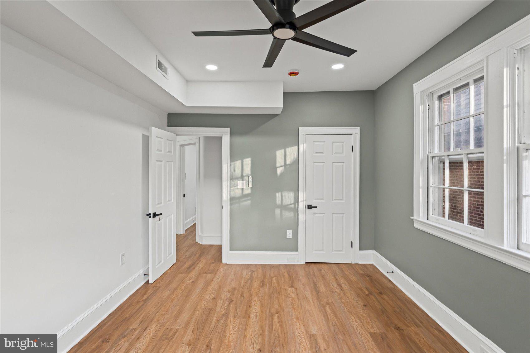 7 York Court Baltimore, MD 21218 - Photo 27 of 42 a view of empty room with wooden floor and fan