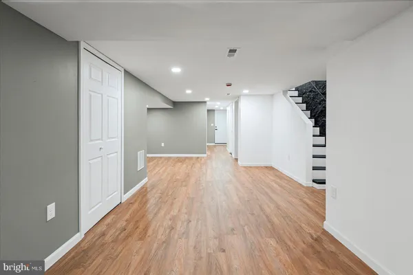 a view of a hallway with wooden floor