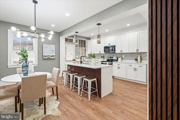 a kitchen with kitchen island granite countertop a center island a sink stainless steel appliances and cabinets